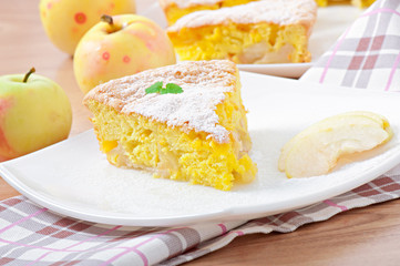 Slice of apple fruit pie on a plate decorated with mint leaf