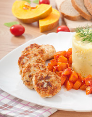 Fried cutlets, stewed pumpkin and mashed potatoes