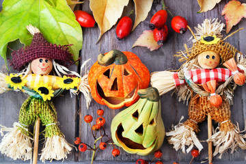 Halloween pumpkins with two scarecrows , still life.