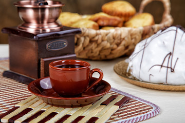 Still-life with a cup of coffee  pie and coffee grinder