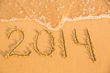 2014 numbers on the yellow sandy beach