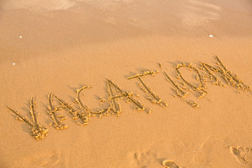 Word vacation on the yellow sandy beach