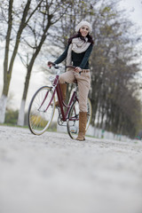 Naklejka premium Young woman on the bicycle