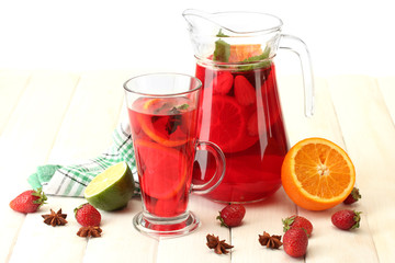 sangria in jar and glass with fruits,