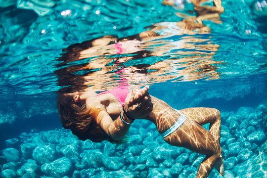 Woman Floating In Natural Pool