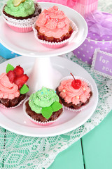 Delicious beautiful  cupcakes on festive table close-up