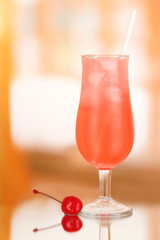 Cherry cocktail with ice on room background