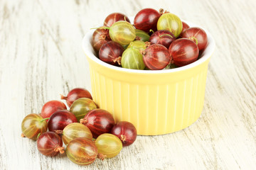 Fresh gooseberries in bowl on table close-up