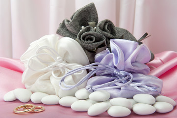  wedding rings and  favors on elegant  fabric