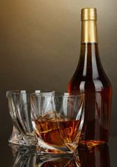 Glass of whiskey with bottle, on dark background