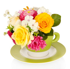 Beautiful bouquet of bright flowers in color mug, isolated