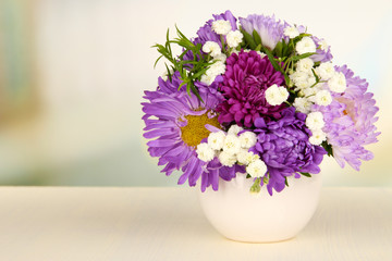 Fototapeta na wymiar Beautiful bouquet of bright flowers in color vase,