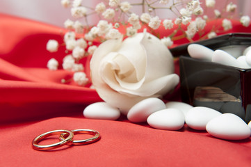  wedding rings and  favors on elegant  fabric