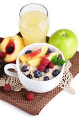 Oatmeal in cup with berries on napkins isolated on white