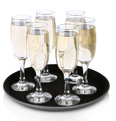 Many glasses of champagne on the tray, isolated on white