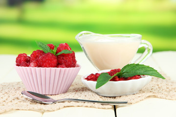 Fresh raspberry, raspberry jam and cream in jug
