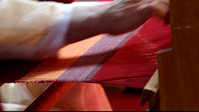 Weaver working on the loom