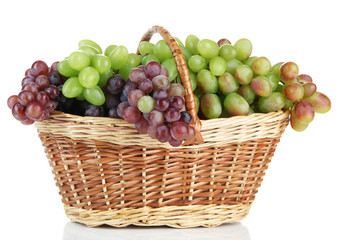 Fresh grape in wicker basket, isolated on white