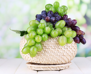 Ripe green and purple grapes in basket