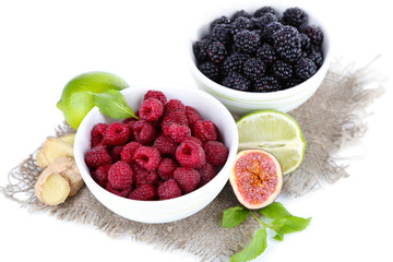 Raspberries and blackberry in small bowls