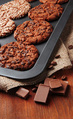 Homemade cookies on dripping pan, on wooden background