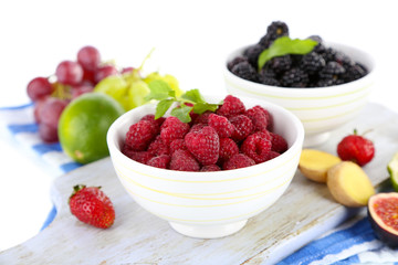 Raspberries and blackberry in small bowls