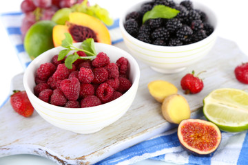 Raspberries and blackberry in small bowls