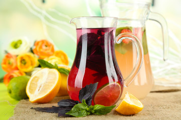 Red basil lemonade in jug and glass,