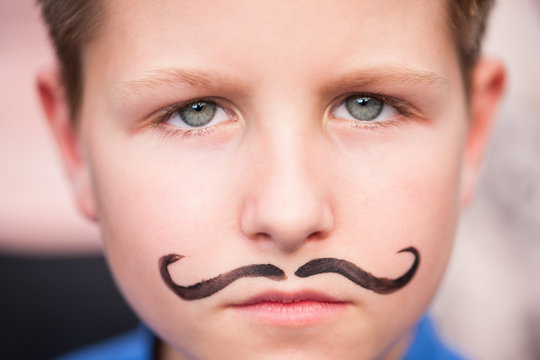 Cute boy with painted mustache