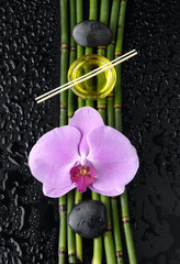 pink orchid and bamboo grove,massage oil,stone, on wet