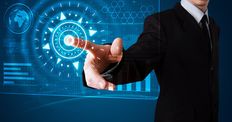 Businessman pressing high tech type of modern buttons