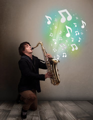 Young musician playing on saxophone while musical notes explodin