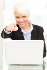 Young female manager with notebook in her office