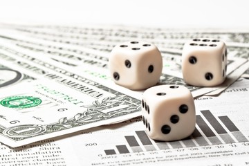dice on financial chart near dollars