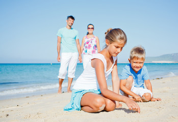 family having fun on beach