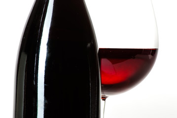 Wine bottle and a glass filled with wine isolated on white