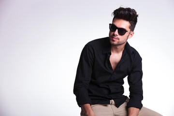 Fototapeta premium seated young man looks to his side