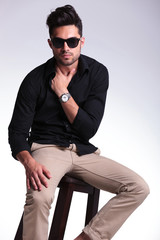 Fototapeta premium seated young man with hand in shirt