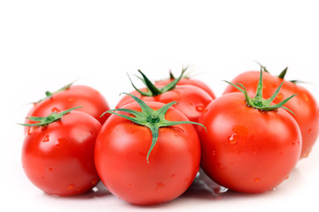 Fresh tomatoes with green leaves.