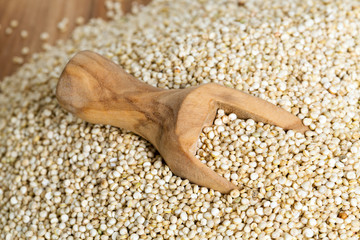 white quinoa on wooden background