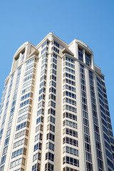 White Condo Tower Under Blue Skies