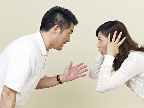 young asian couple shouting at each other