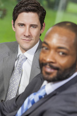 Caucasian & African American Businessman in Office Meeting