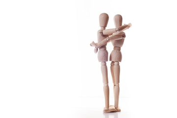 couple wooden manikins hugging