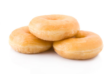 Three doughnuts or donuts piled isolated on white.
