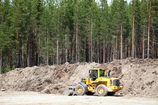 Yellow tractor in sandpit