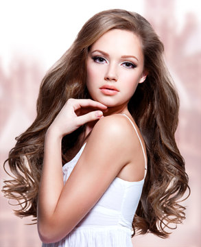 Fototapeta beautiful young woman with  long curly hairs