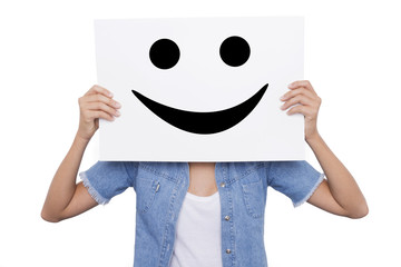 Girl holding a placard with a smiling smiles front of her face