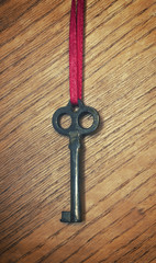 old key on a red ribbon