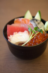 Sushi don , raw salmon tuna octopus on rice